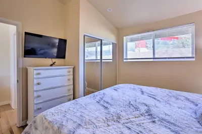 a bedroom with a bed and a dresser and a tv at Oakhurst Duplex about 13 Mi to Yosemite National Park! in Oakhurst