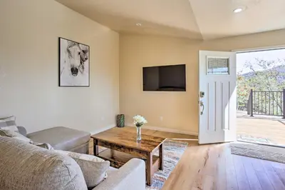 a living room with a couch and a table at Oakhurst Duplex about 13 Mi to Yosemite National Park! in Oakhurst