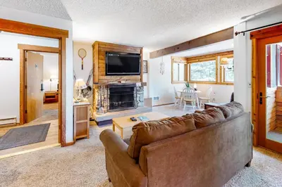 a living room with a couch and a fireplace at Master Units 18A & B at Granlibakken in Tahoe City