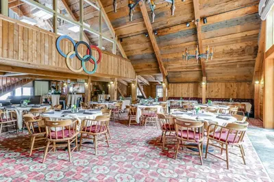 a dining room with tables and chairs with olympics signs at Master Units 18A & B at Granlibakken in Tahoe City