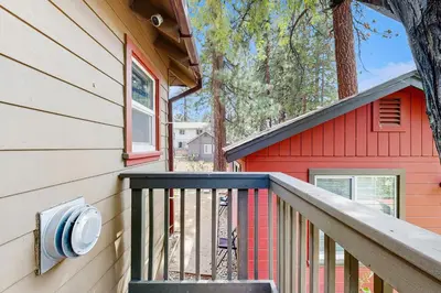 a house with a red building and a balcony at Manzanita Holiday in South Lake Tahoe
