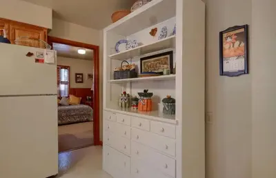 a large white cabinet in a kitchen with a refrigerator at Robins Nest- Lake Area Free Night Special in Bass Lake