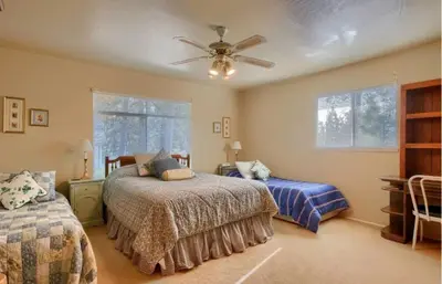 a bedroom with two beds and a ceiling fan at Robins Nest- Lake Area Free Night Special in Bass Lake