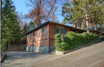 a small wooden house in the middle of a street at Robins Nest- Lake Area Free Night Special in Bass Lake