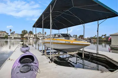 a boat is docked at a dock in the water at Bellanca in Discovery Bay