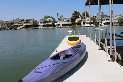a purple boat is parked at a dock at Bellanca in Discovery Bay