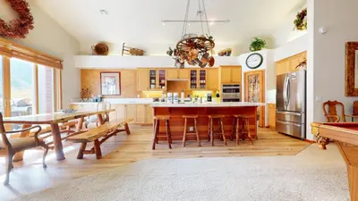 a kitchen with a table and chairs and a refrigerator at Snowcreek V #757 condo in Mammoth Lakes