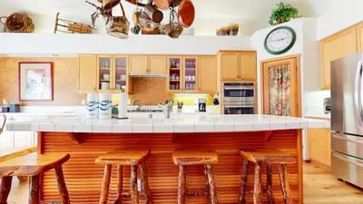 a kitchen with a large island with bar stools at Snowcreek V #757 condo in Mammoth Lakes