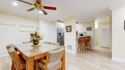 a dining room and living room with a ceiling fan at Summit #245 condo in Mammoth Lakes