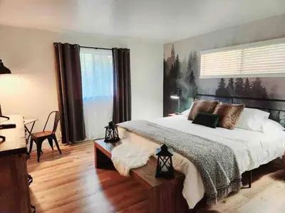 a bedroom with a large bed and a large window at FirePit~Horseshoes~King Bed~Near Lake, Wine, Farms in Pollock Pines