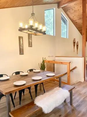 a dining room with a wooden table and chairs at FirePit~Horseshoes~King Bed~Near Lake, Wine, Farms in Pollock Pines