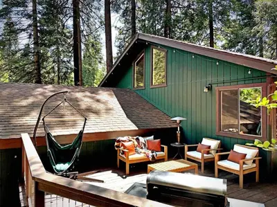 a green house with a hammock on a deck at FirePit~Horseshoes~King Bed~Near Lake, Wine, Farms in Pollock Pines