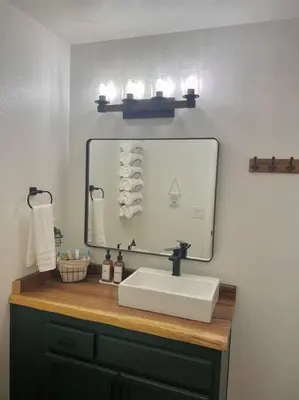 a bathroom with a sink and a mirror and towels at FirePit~Horseshoes~King Bed~Near Lake, Wine, Farms in Pollock Pines