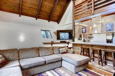 a living room with a couch and a bar at Yosemite's Creekside Birdhouse in Wawona