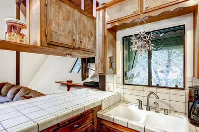 a kitchen with a sink and a window at Yosemite's Creekside Birdhouse in Wawona