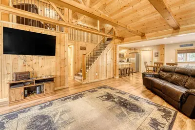 a living room with a couch and a flat screen tv at Black Bear Hideaway in South Lake Tahoe