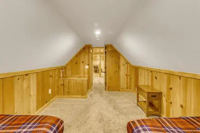 a room with wooden walls and two beds in it at Black Bear Hideaway in South Lake Tahoe