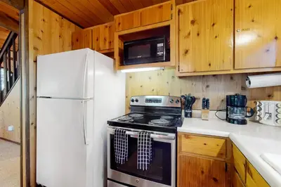 a kitchen with a stove and a refrigerator at Cresta Cabin in Arnold