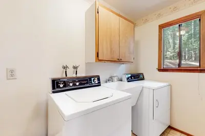 a small kitchen with a washer and dryer in it at Cresta Cabin in Arnold