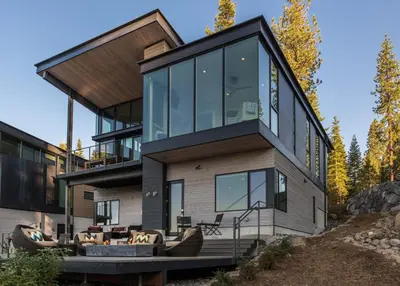 a house on a hill with glass windows at Modern Ski In-Out Home, Mid-Mountain in Truckee