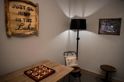 a room with a table and a lamp and a sign at Modern Ski In-Out Home, Mid-Mountain in Truckee