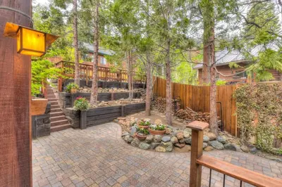a backyard with a wooden fence and a wooden bench at Crystal Bay Lakeview in Crystal Bay