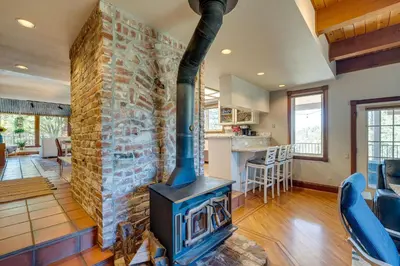 a fireplace in the living room of a house at Meadow Vista Mountain Escape with River Views! in Meadow Vista
