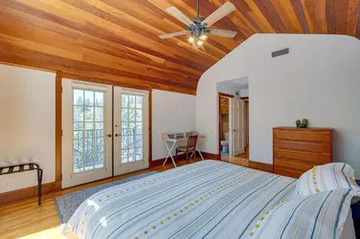 a bedroom with a large bed with a wooden ceiling at Meadow Vista Mountain Escape with River Views! in Meadow Vista