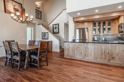 a kitchen with a wooden table and wooden cabinets at Updated 2 Bedroom Plus Loft 3 Bathroom Snowcreek Phase V #860 Sleeps 6 in Mammoth Lakes