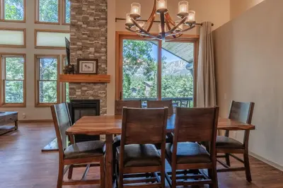 a dining room with a table and chairs and a fireplace at Updated 2 Bedroom Plus Loft 3 Bathroom Snowcreek Phase V #860 Sleeps 6 in Mammoth Lakes