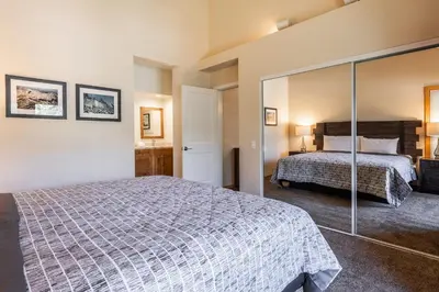 a bedroom with a bed and a large mirror at Updated 2 Bedroom Plus Loft 3 Bathroom Snowcreek Phase V #860 Sleeps 6 in Mammoth Lakes