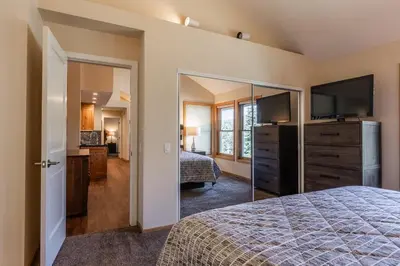 a bedroom with a bed and a dresser with a television at Updated 2 Bedroom Plus Loft 3 Bathroom Snowcreek Phase V #860 Sleeps 6 in Mammoth Lakes