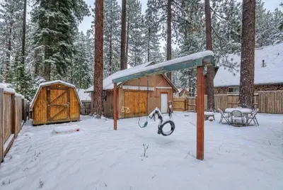 a playground in the snow next to a cabin at Agate Bay 3BDR, Walking Distance to the Beach! in Tahoe Vista