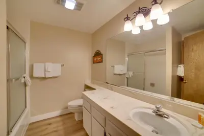 a bathroom with a sink and a toilet and a mirror at Mammoth Lakes Vacation Rental 1 Mi to Ski Area! in Mammoth Lakes