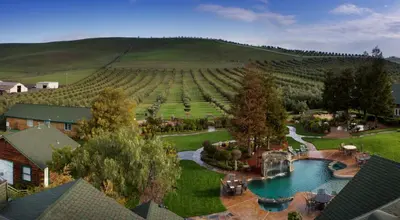 an aerial view of a estate with a pool and a vineyard at Purple Orchid Resort & Spa in Livermore