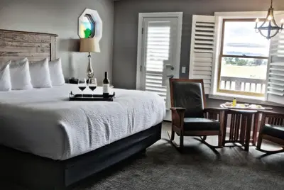 a bedroom with a bed and a desk and a chair at Purple Orchid Resort & Spa in Livermore