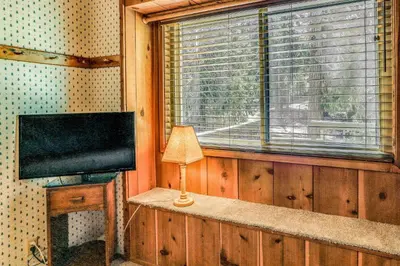 a living room with a television and a window at 3 Mi to Shaver Lake Cozy Bears Hideaway Cabin! in Shaver Lake