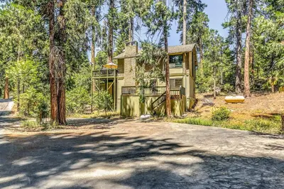 a house in the woods with a driveway at 3 Mi to Shaver Lake Cozy Bears Hideaway Cabin! in Shaver Lake