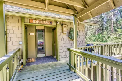 a front porch of a building with a sign that reads bank maximize at 3 Mi to Shaver Lake Cozy Bears Hideaway Cabin! in Shaver Lake