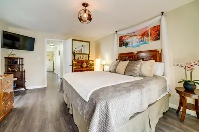 a bedroom with a large bed and a tv at Pet-Friendly Home with Hot Tub! 6 Mi to Dtwn Reno in Reno