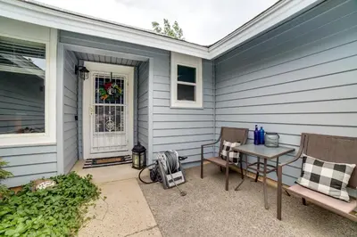 a patio with two chairs and a table on a house at Pet-Friendly Home with Hot Tub! 6 Mi to Dtwn Reno in Reno