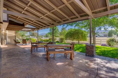 a patio with tables and chairs and a wooden roof at @ Marbella Lane - Eccentric 4BR Modern Ranch Home in Reno