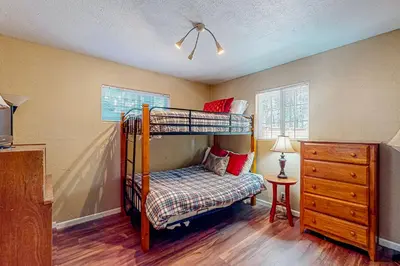 a bedroom with a bunk bed and a dresser at Hounds of Aspen in South Lake Tahoe