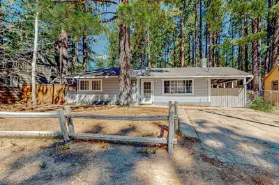 a white house with a fence in front of it at Hounds of Aspen in South Lake Tahoe