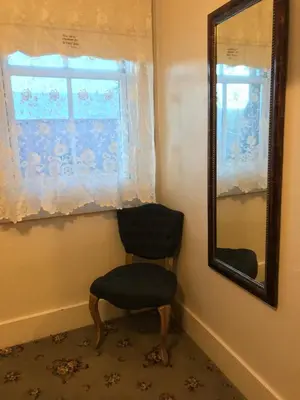 a chair and a mirror in a room at Hotel Sutter in Sutter Creek