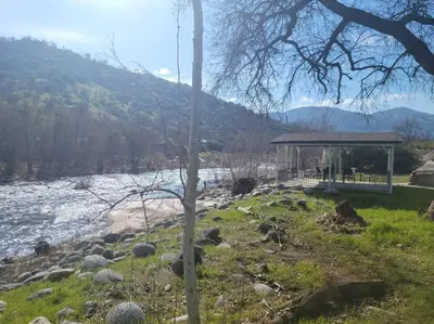 a gazebo next to a river with a mountain at Oasis Riverfront House -10 min to Sequoia in Three Rivers
