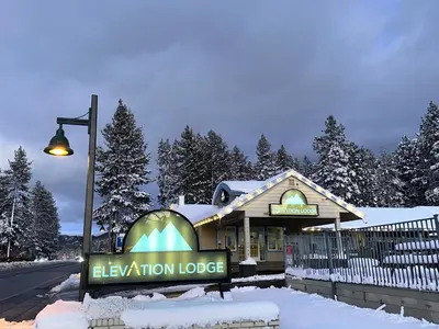 a sign for a relaxation lodge in the snow at Elevation Lodge in South Lake Tahoe