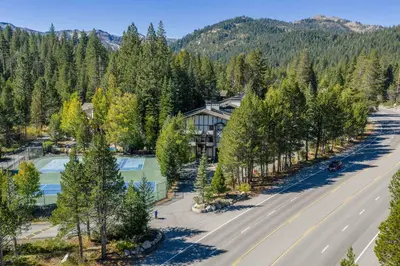 an aerial view of a resort with a road and trees at 2BDR Condo - Three Minutes to Olympic Valley! in Tahoe City