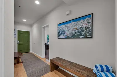 a living room with a large picture on the wall at 2BDR Condo - Three Minutes to Olympic Valley! in Tahoe City