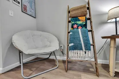 a white chair next to a ladder with a blanket at 2BDR Condo - Three Minutes to Olympic Valley! in Tahoe City